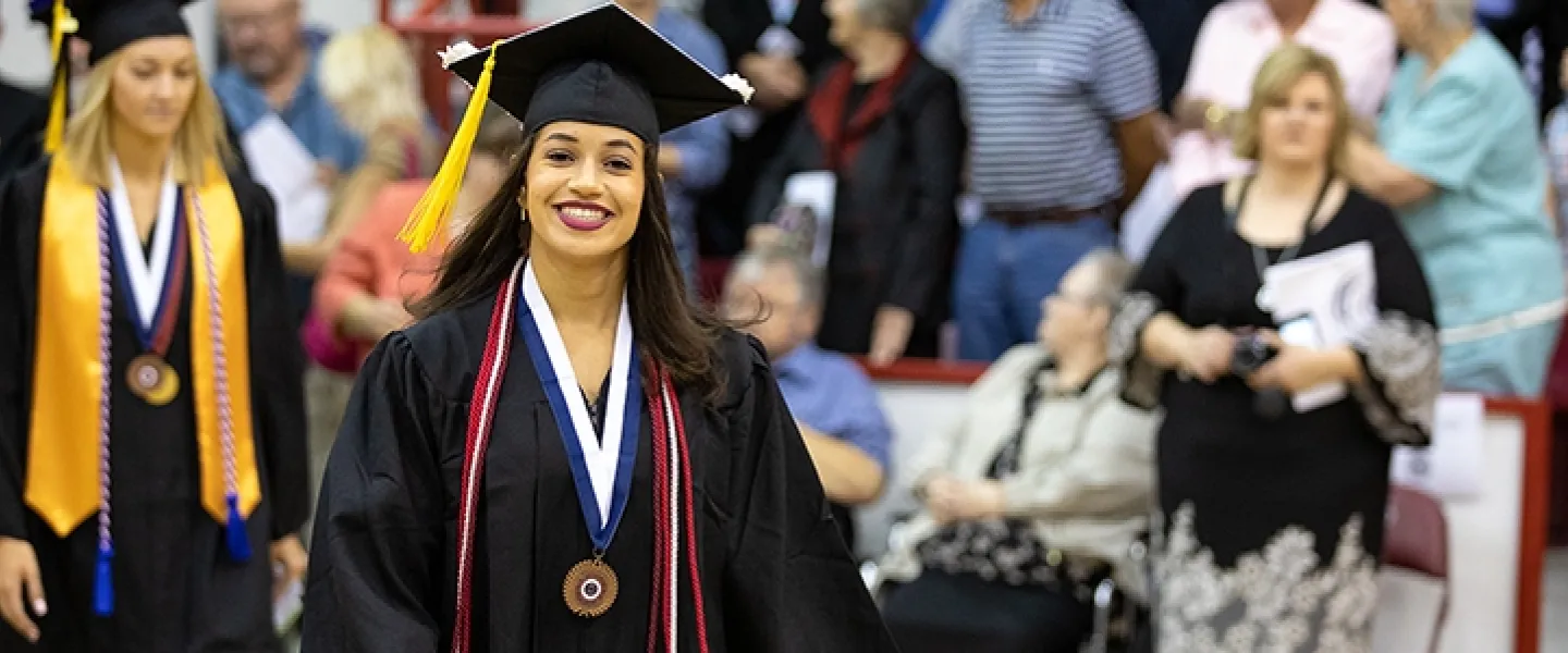A student wearing a cap and gown