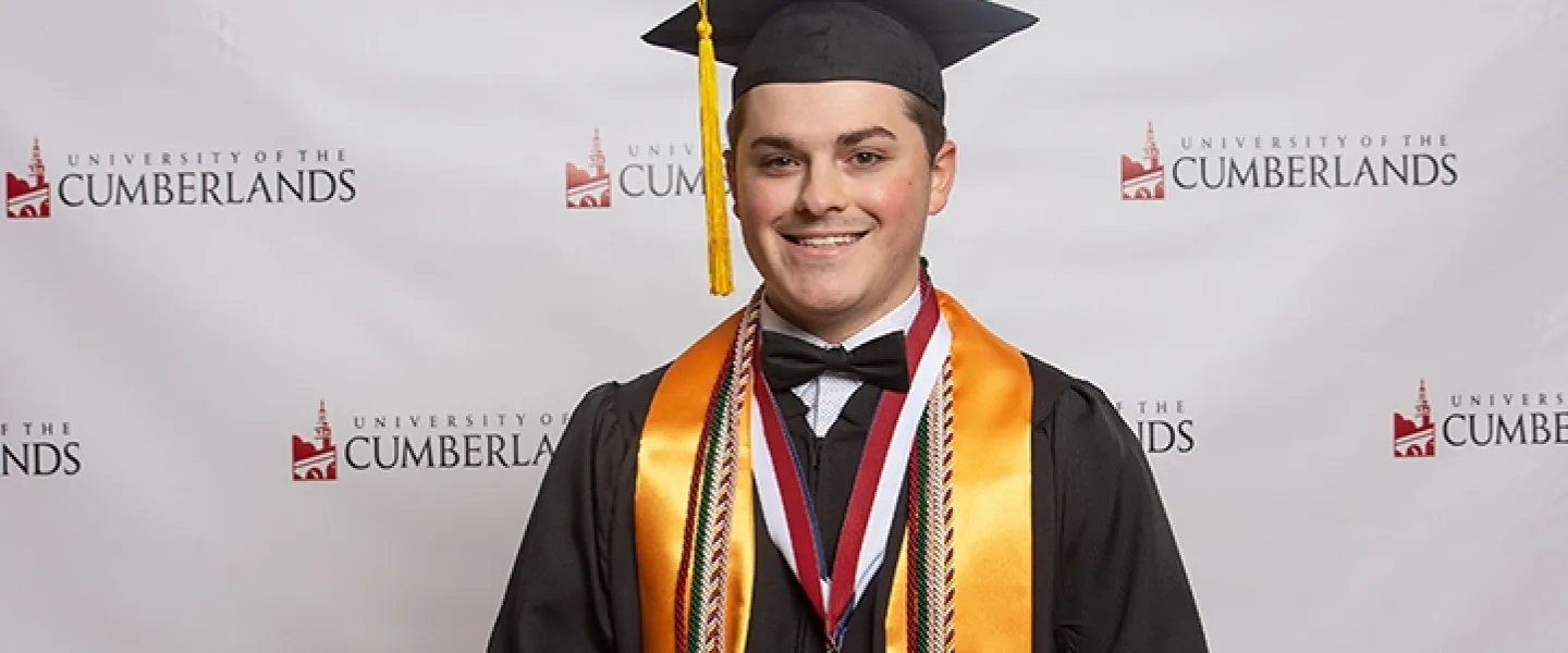 A student wearing a cap and gown