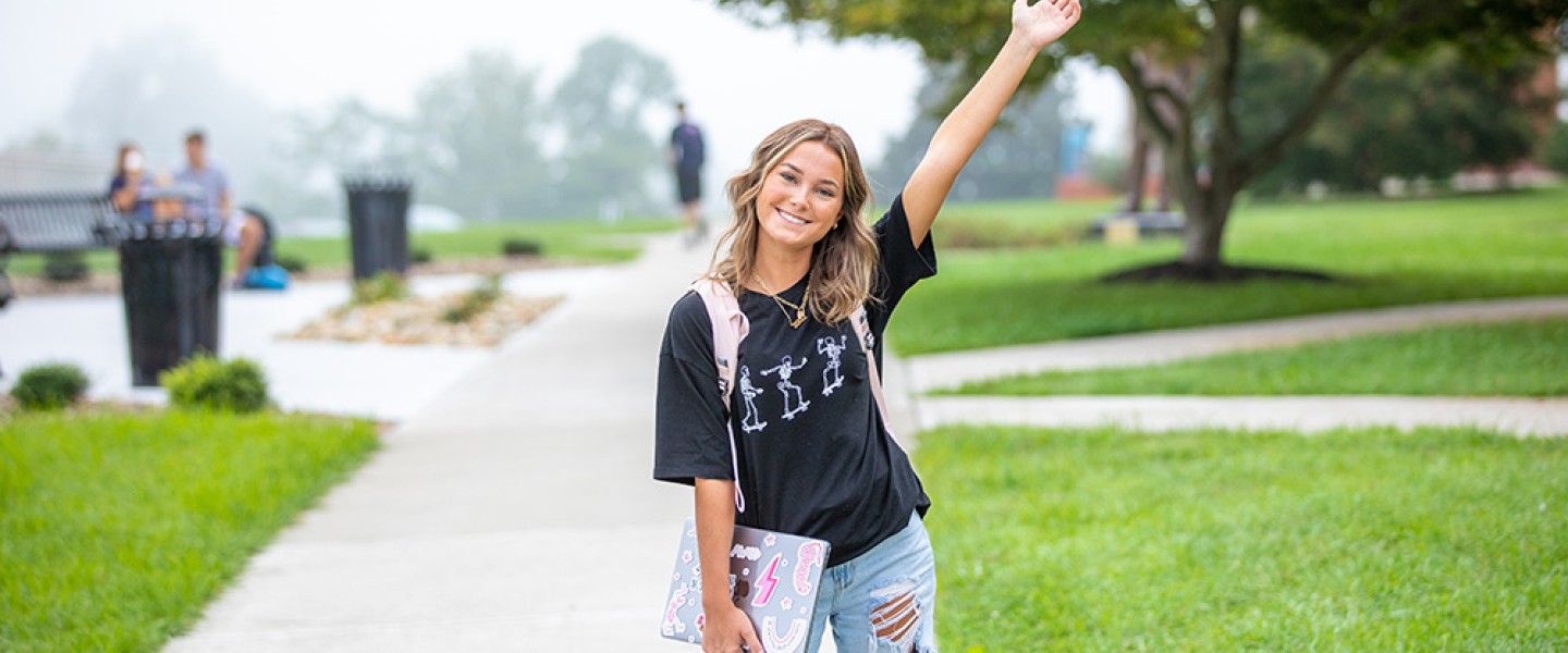 Student poses for a photo on campus