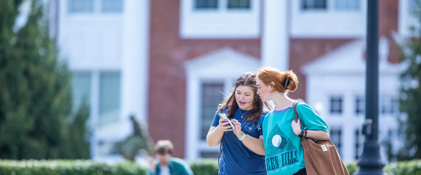Two students walking outside on campus