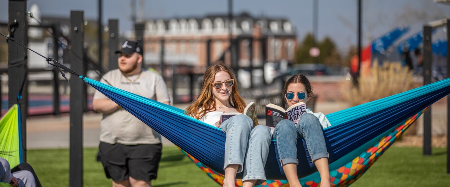 Two students sitting on a hammock
