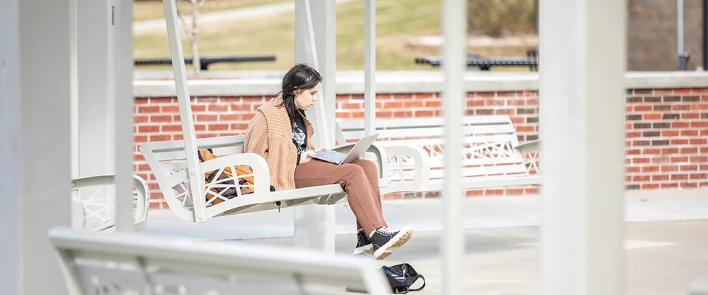 Girl using a laptop outdoors