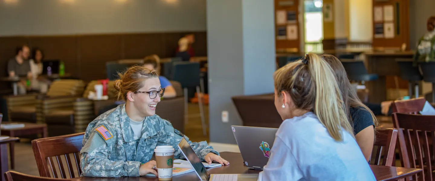 Military cadet speaking with fellow students