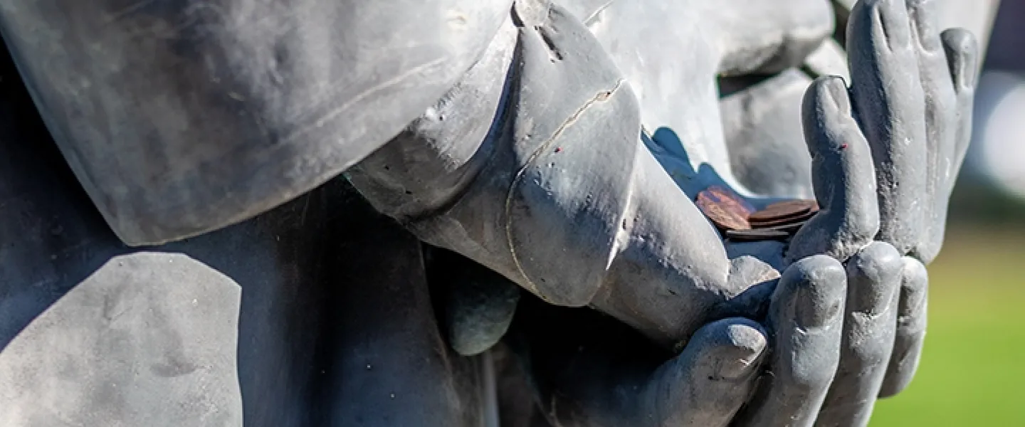 Statue holding coins