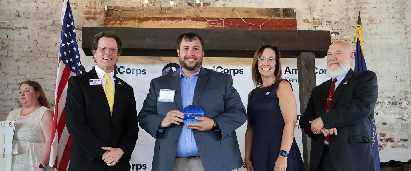 Campus Minister Jacob Ratliff is presented with a Governor's Service Award. 