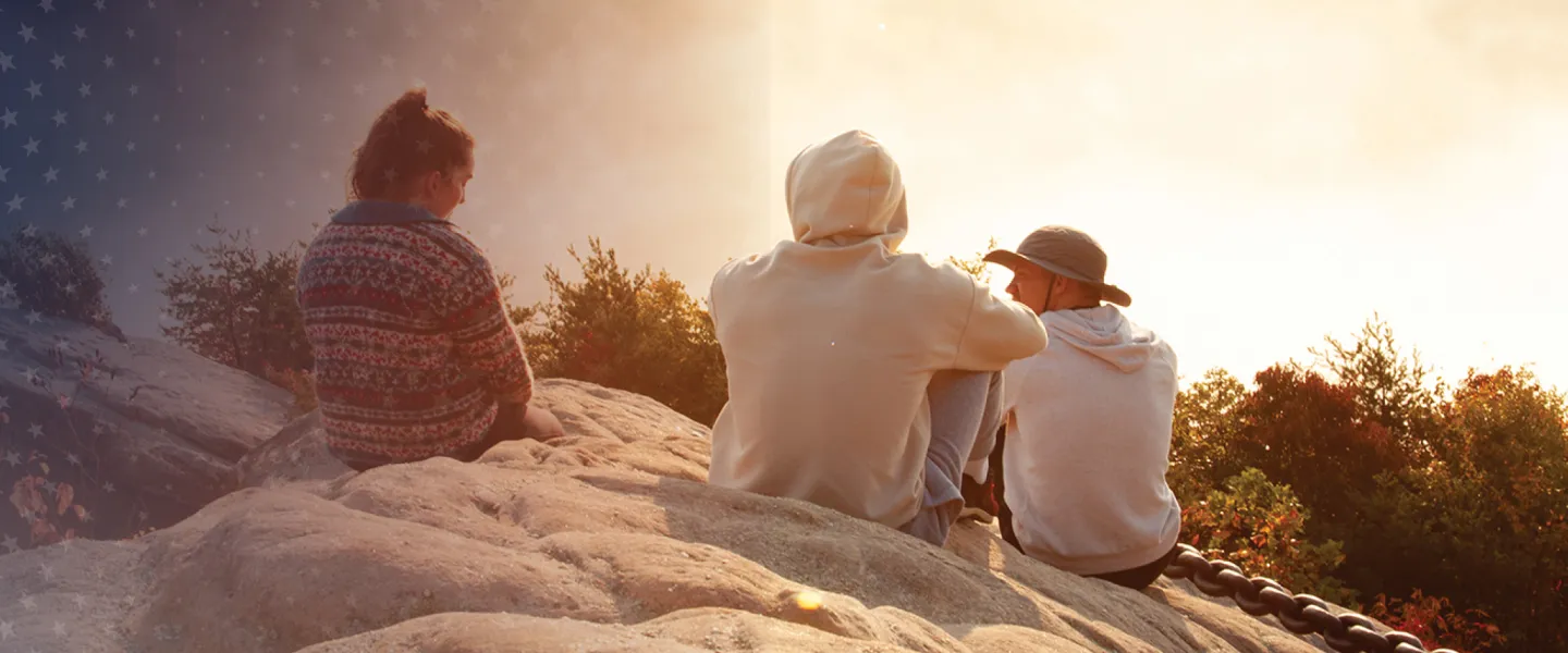 College students take in a sunrise at Chain Rock. 
