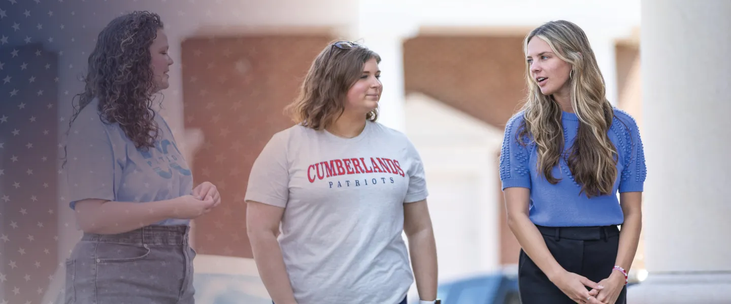 Students walk on campus while discussing their day. 