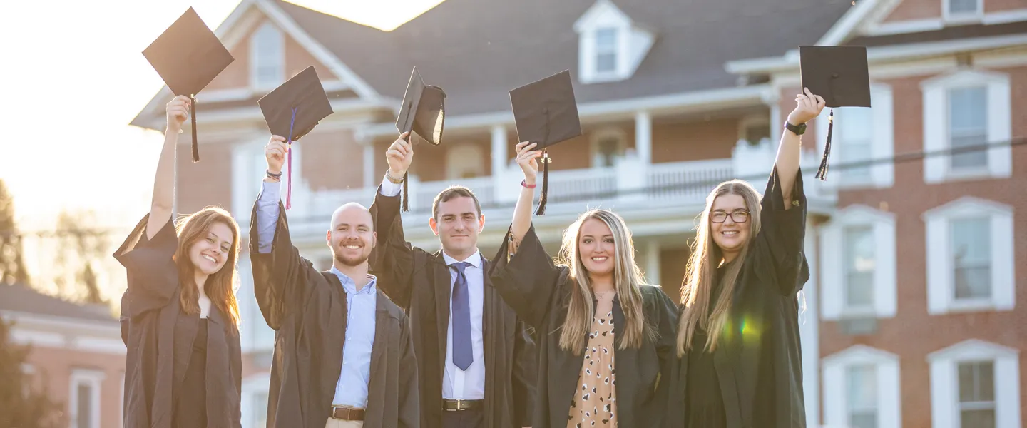 Students share a moment as they prepare for graduation. 