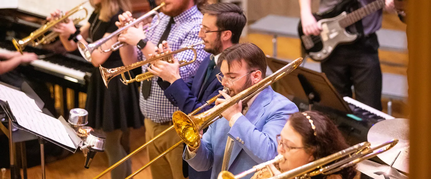 Band students practice a musical selection in the university recital hall. 