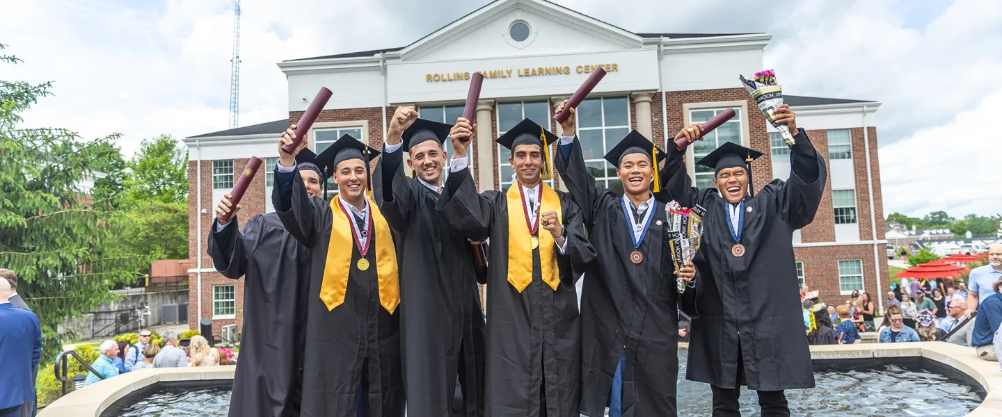 Students celebrate with their diploma following graduation.