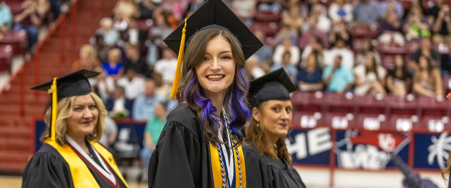 A student walks into her graduation ceremony. 