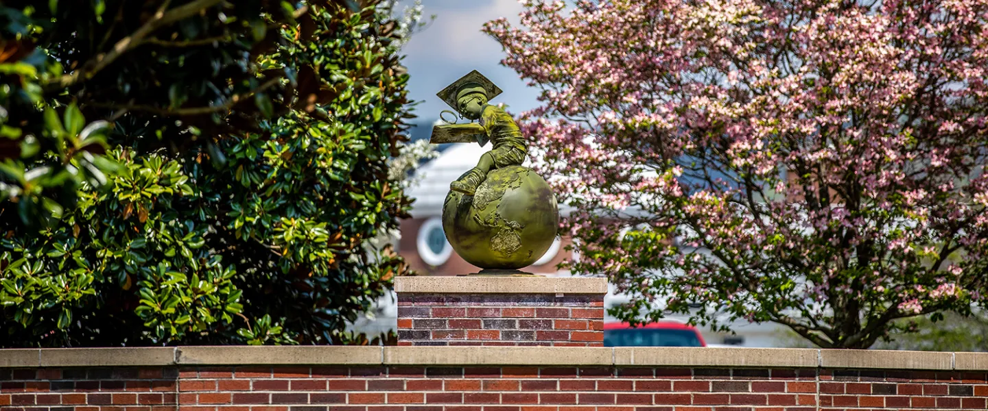 The globe statue in front of the education building. 
