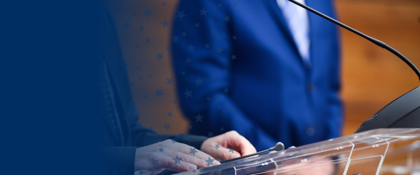 Person Speaking at Podium