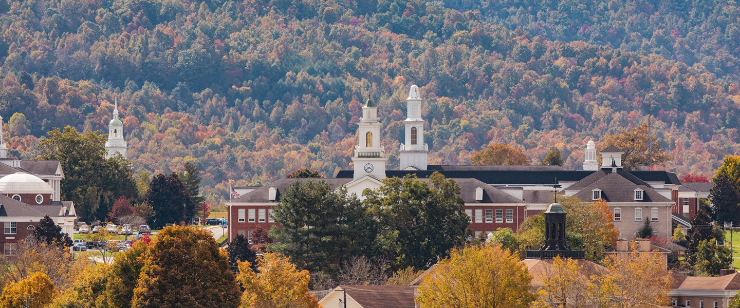 A view of campus depicting several buildings among the autumn foliage. 