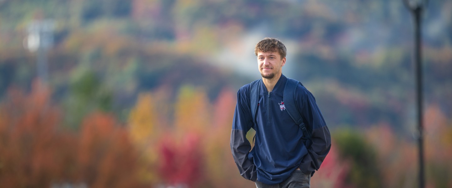 A male Cumberlands student walks across campus on a fall morning. 