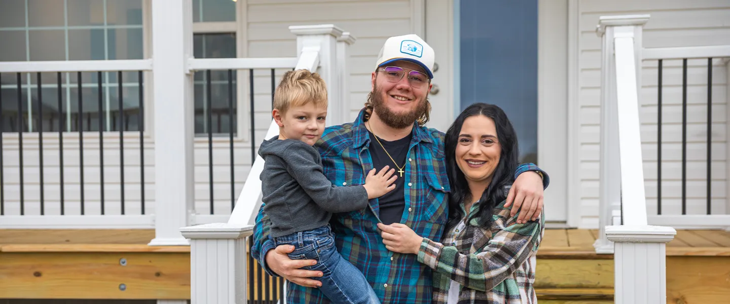 The Perry family poses for a photo in front of a new home constructed by Mountain Outreach. 