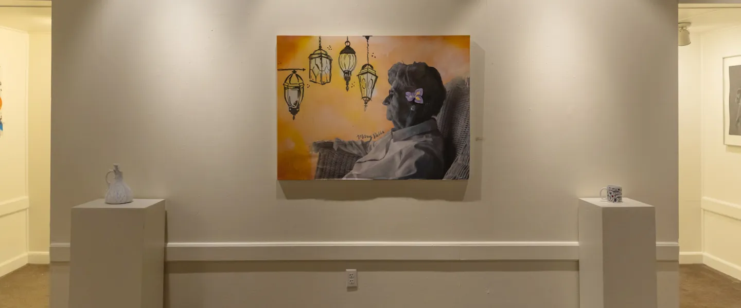 A student painting of an older woman inside the Cumberlands art gallery. 