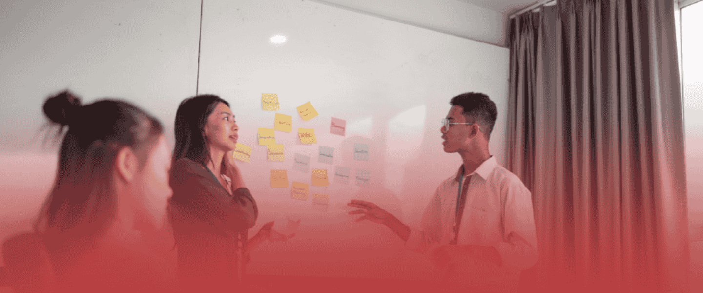 Project Managers Discussing Solutions at a Whiteboard