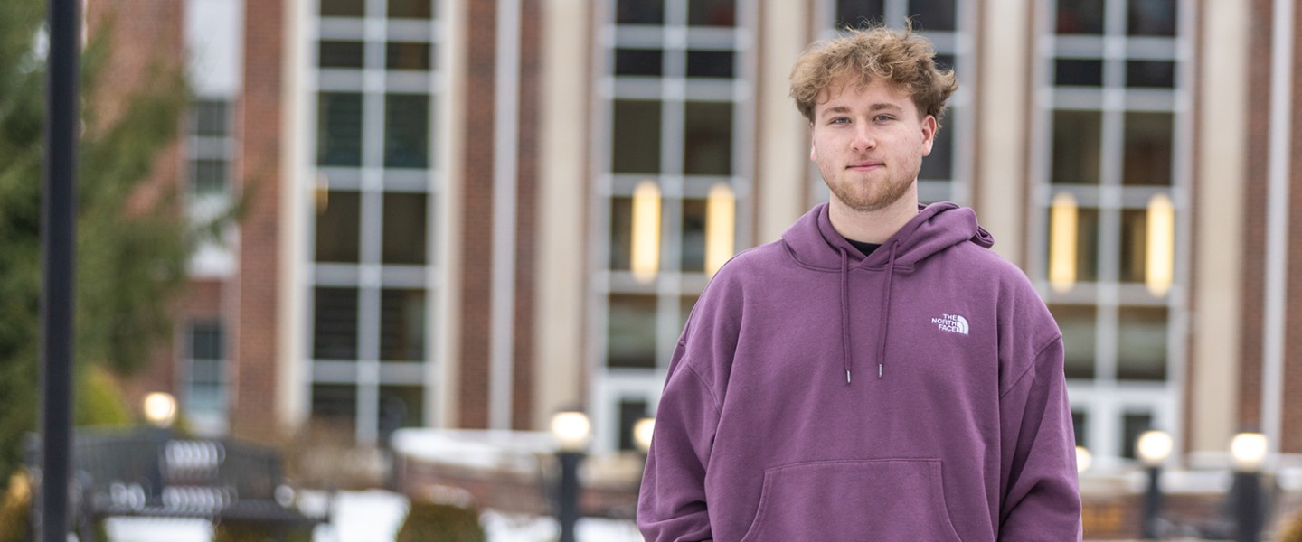 Commuter student Jackson Reece poses for a photo in front of the library. 