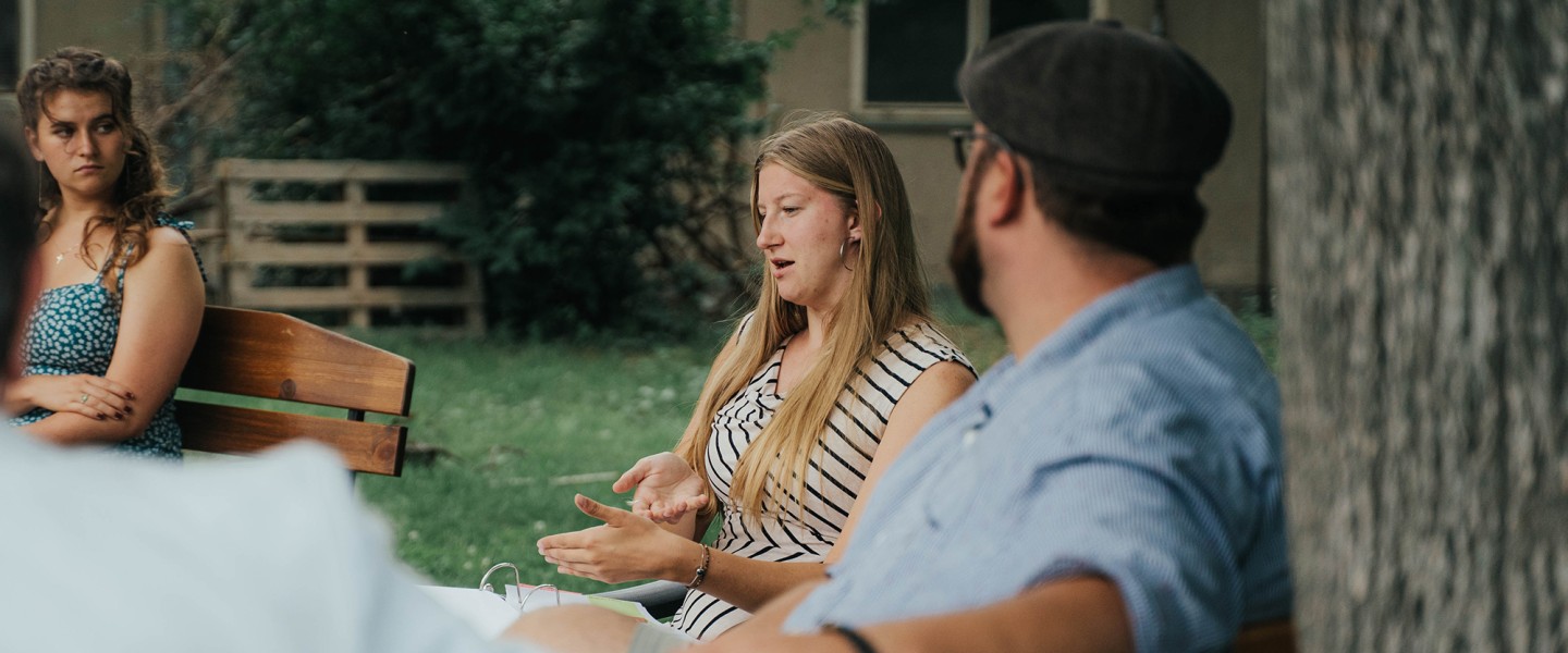 Student Liberty Poley discusses her time at Cumberlands outside in a circle of friends. 