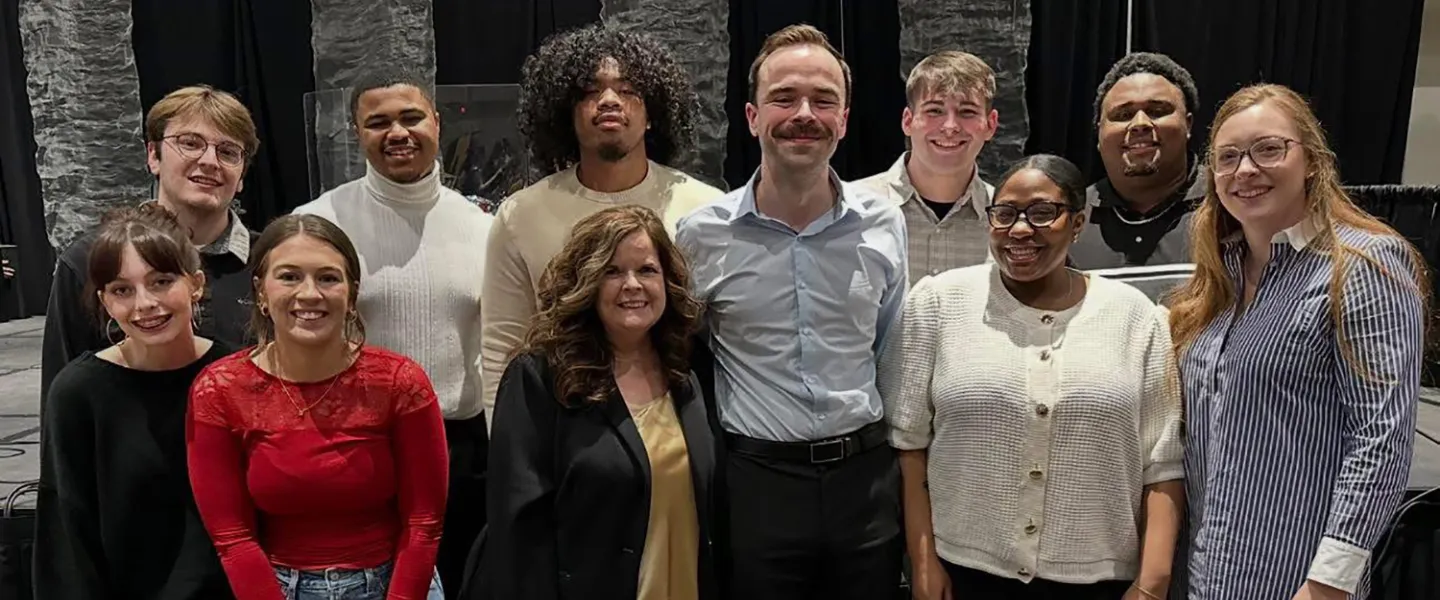 Lisa Bartram stands with a group of students after being recognized by the Association for the Promotion of Campus Activities. 