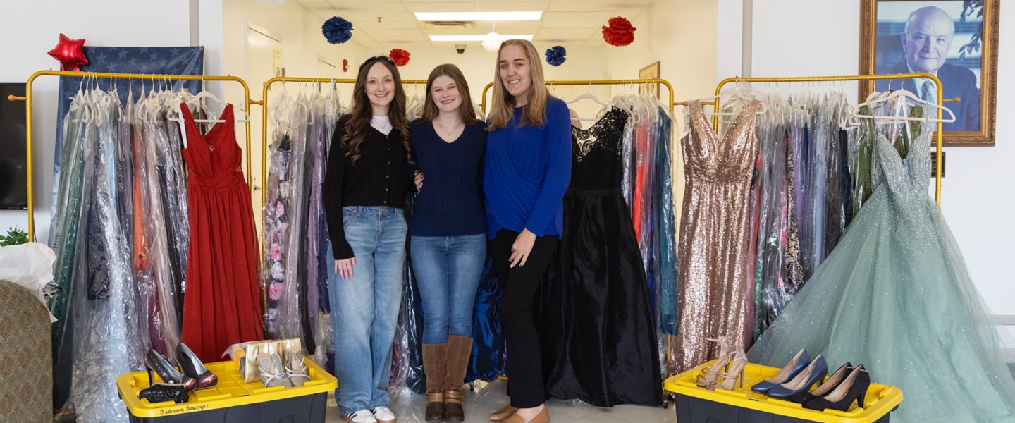 Cumberlands students Ella Edington, Abigail Wynn, and Caitlin Ball pose with prom dresses they have collected to give away to support local high school students. 