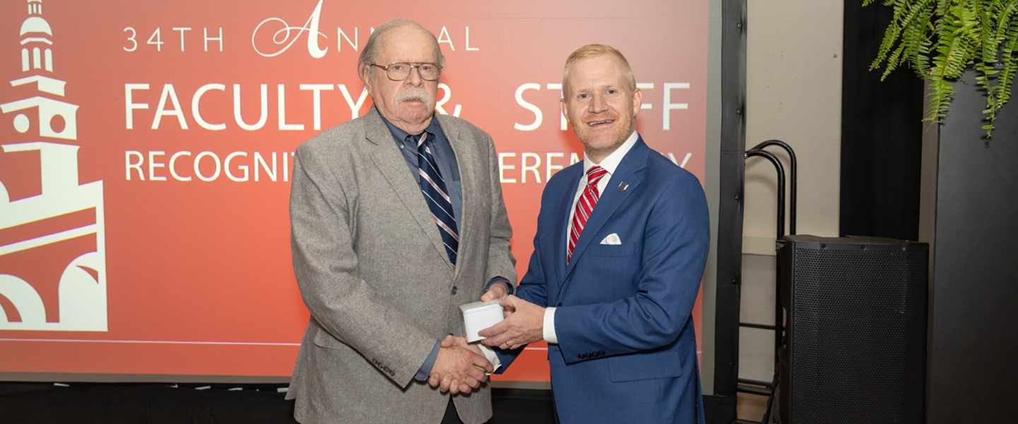 Dr. Tom Frazier is honored at his retirement by President Quentin Young. 