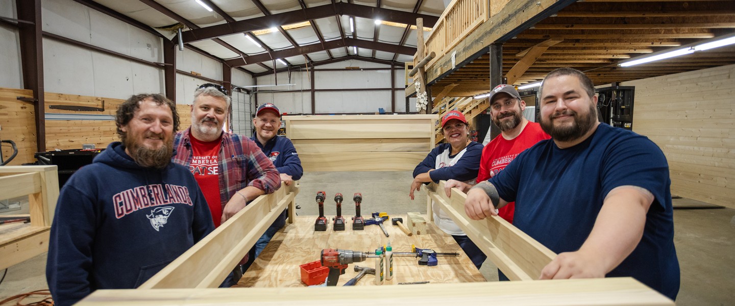 A group of Cumberlands staff members show off a bed they constructed during a service day event.