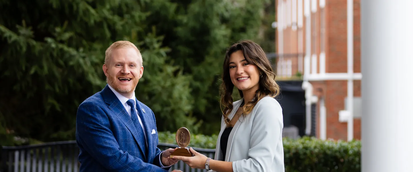 President Young presents an academic award to Joy Kendrick.
