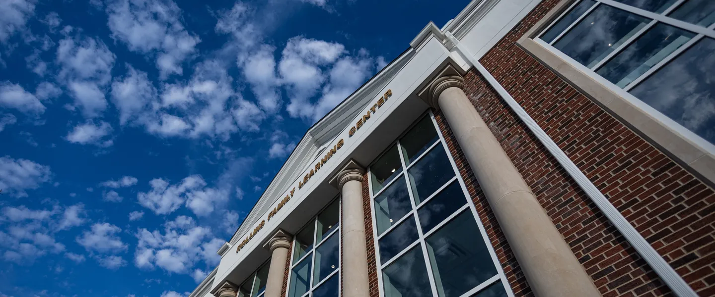 A view of a cloudy sky above the Rollins Family Learning Center. 