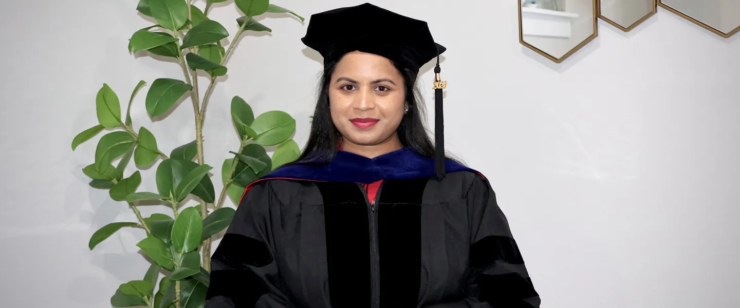 Dr. Saika Anumula posing in her cap and gown. 
