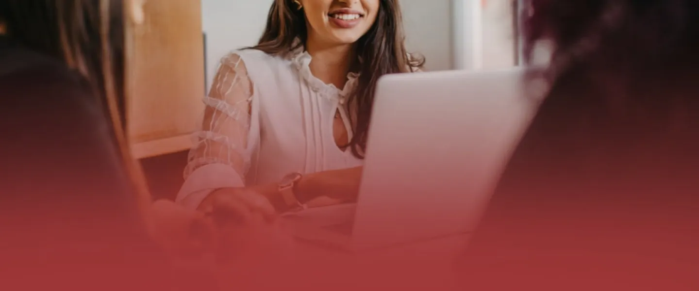 Communications Professional on Laptop with Clients