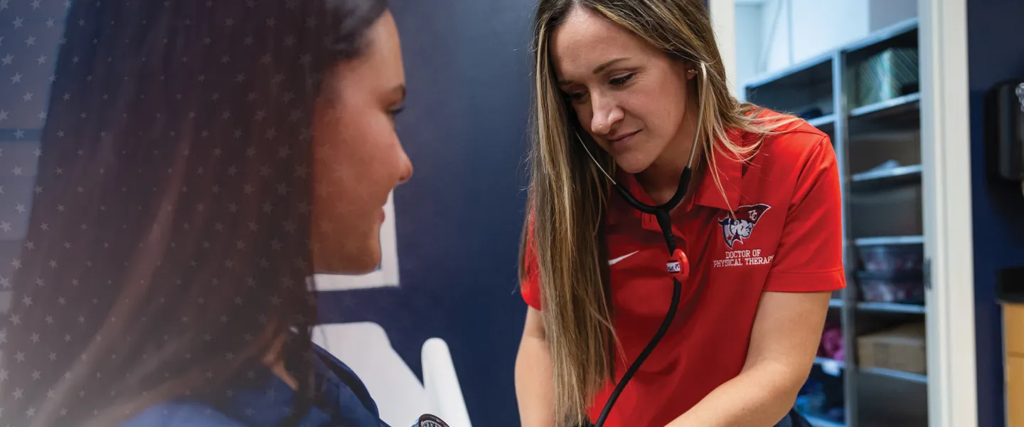 A healthcare student takes the blood pressure of a patient. 