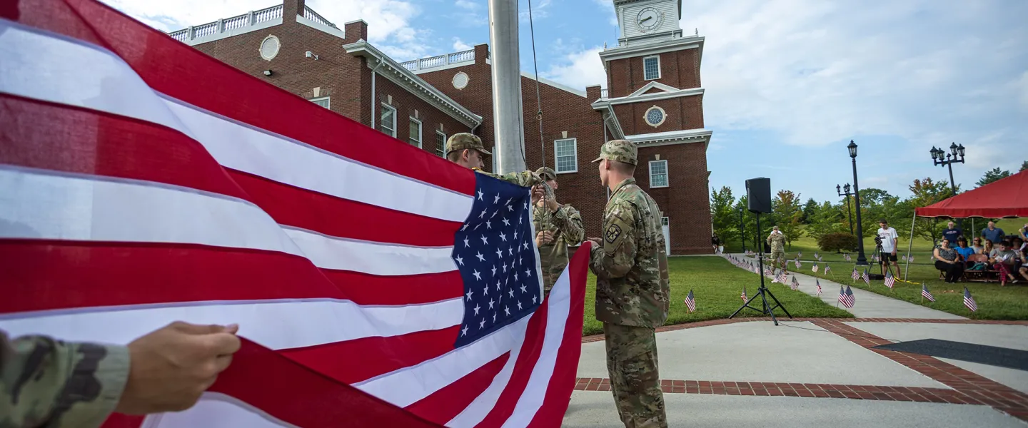 ROTC cadets present the American flag during a campus ceremony. 