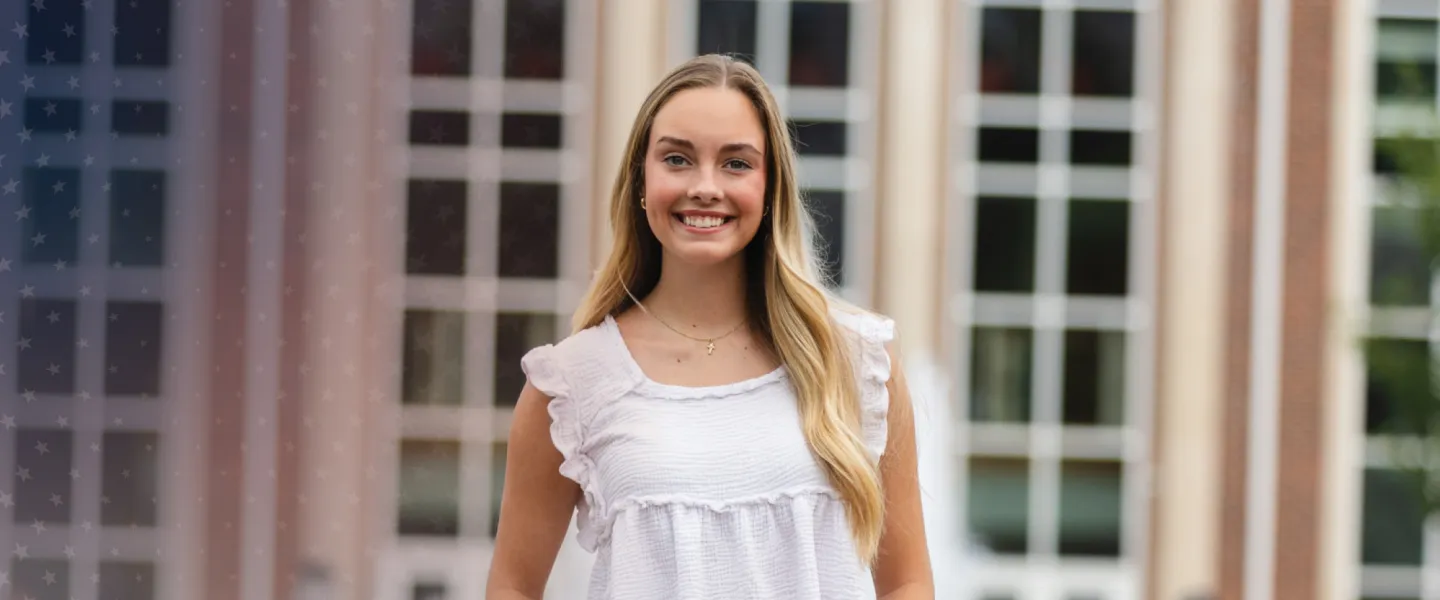 Commuter student Sydney Hurst posing in front of the library. 