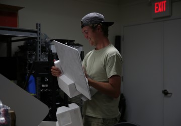 A student placing an item into styrofoam