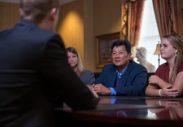 A group of people seated at a business table