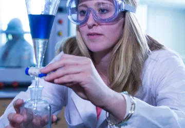 A chemist mixing chemicals