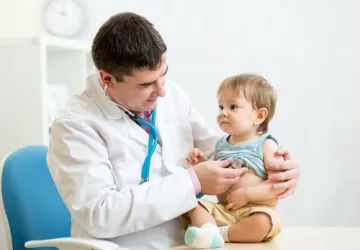A doctor using a stethoscope on a child