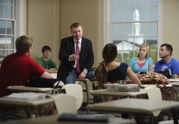 A man speaking to a class 