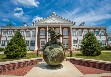 Bronze statue in front of a campus building