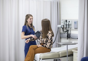 A nurse taking a patient's blood pressure
