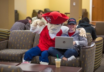 University mascot posing with a student