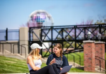Two students having a conversation outside