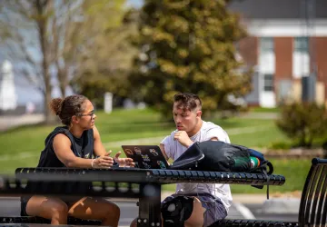 Two students looking at a laptop