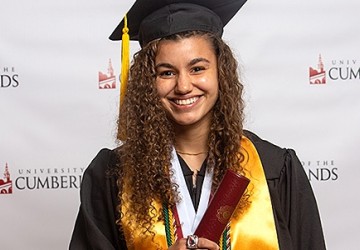 A student wearing a cap and gown