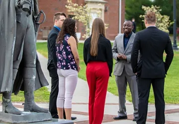 Several people standing outside having a conversation