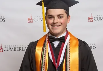 A student wearing a cap and gown