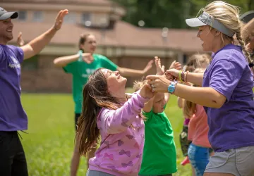 Students leading children in summer camp activities