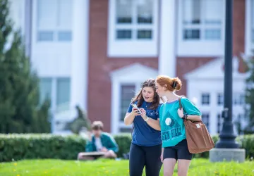 Two students walking outside on campus